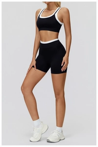 Detail view of contrast trim yoga set with high-waist shorts and racerback sports bra