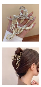 Detail of metallic bow hair claws in gold and silver with pearl accent on model