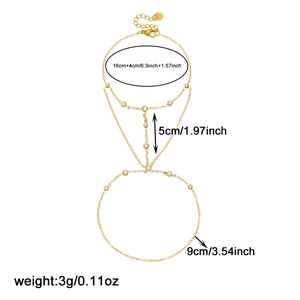 Gold plated stainless steel hand harness with round crystal accents and size markings