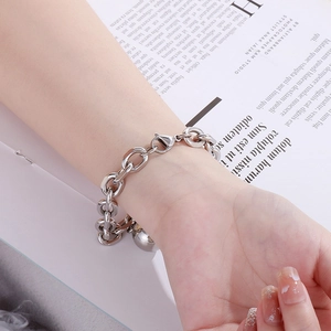 Detail of silver hollow steel ball bracelet with chunky chain links on a model wrist