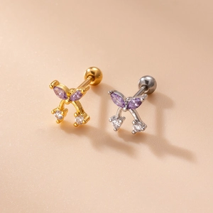 Detail of silver and gold butterfly stud earrings with purple crystals and screw ball backings