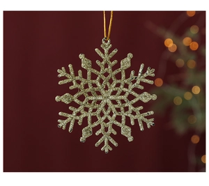Close-up of golden glitter snowflake ornament with hanging string for Christmas tree decor