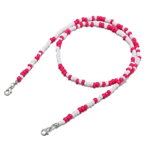 Close-up of pink and white beaded lanyard with metallic lobster clasps for eyewear