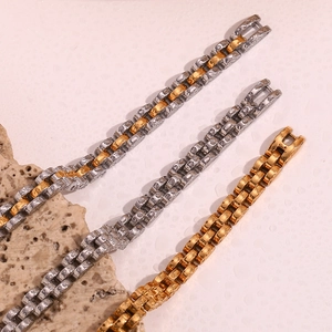 Macro detail of three 18K gold plated watch-style link bracelets with water droplets