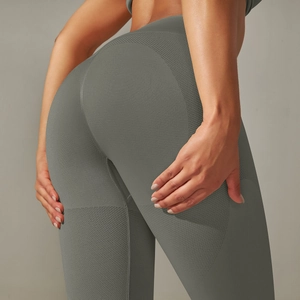 Detailed close-up of high-waist seamless sage green yoga pants with scrunch butt lifting seam