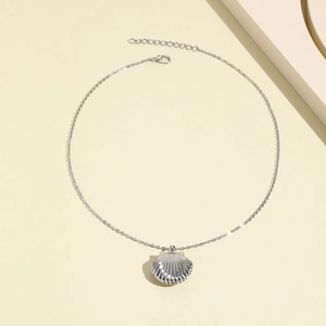 Macro view of silver shell locket necklace with fine chain and adjustable lobster clasp