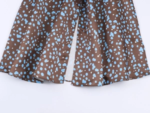 Detail of vintage brown and blue polka dot satin dress showing high slit hem design