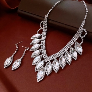Detail of silver water-drop fringe necklace and earrings set with sparkling crystals