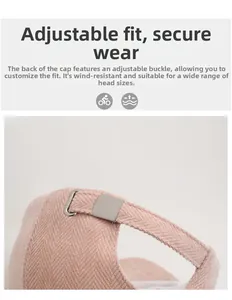 Detail of pink herringbone baseball cap showing adjustable metal buckle and thick fabric