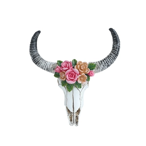Bohemian bull skull wall decor with colorful resin roses and black horns on white background