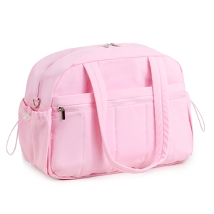 Detail of pink waterproof travel bag showing front zipper pocket and drawstring side pouch
