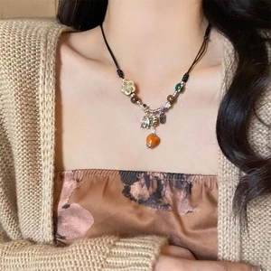 Ethnic ceramic heart beaded necklace with orange persimmon pendant on black cord