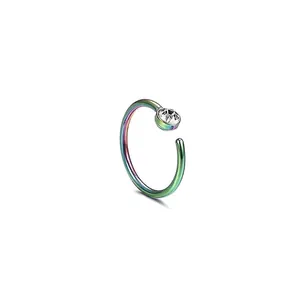 Macro detail of rainbow stainless steel C-shaped nose ring with a clear zircon stone