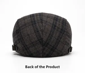 Detail view of adjustable leather straps and bronze metal buckle on checkered flat cap