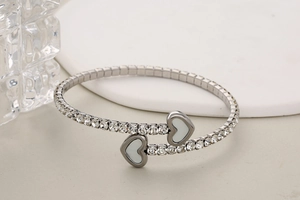 Detail of silver heart pendants and crystal paving on the stainless steel open bangle