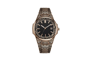 Macro detail of bronze retro watch showing intricate floral engravings and date window