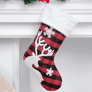 Red and black plaid Christmas stocking with white reindeer and snowflake embroidery details