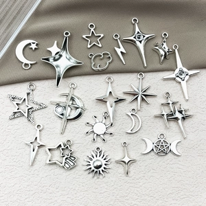 Detail of silver alloy star and moon charms for DIY jewelry making and necklaces