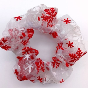 Close-up of white mesh hair scrunchie with festive red and white snowflake patterns