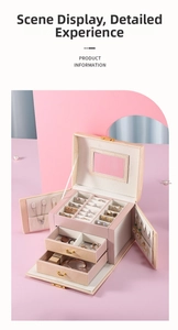 Detailed view of pink three-layer jewelry box featuring a vanity mirror and organized slots