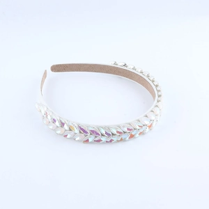 Chic headband with rainbow leaf rhinestones and white pearls on a sleek white base