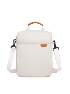 Close-up of beige Oxford fabric laptop bag featuring brown leather handles and stitching