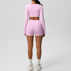 Rear view of light pink two-piece yoga set featuring cropped long sleeve and high waist shorts