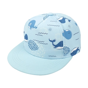 Detail shot of light blue kids snapback hat with navy whale patterns on white background