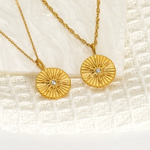 18K gold plated stainless steel starburst medallion necklace with cubic zirconia