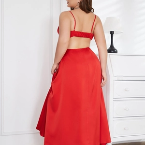 Detail view of red satin backless maxi dress with cross-tie design and glossy texture