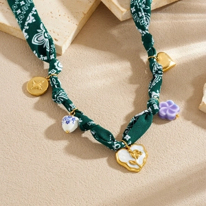 Floral fabric ribbon necklace with gold plated heart charms and painted flower pendants