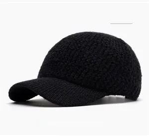 Detail view of the black knit texture and curved brim of the winter baseball cap
