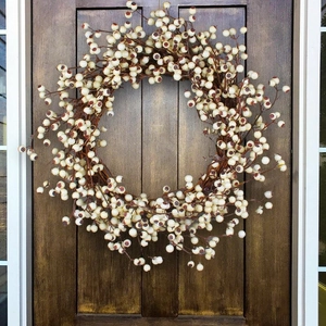 Ivory berry Christmas wreath on dark wood door for rustic holiday home wall decoration