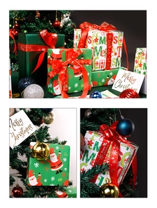 Close-up of Santa Claus wrapping paper, festive red ribbon, and Merry Christmas gift box