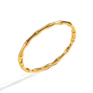 Dettaglio della trama in bambù dorato sul bracciale minimalista placcato oro 18K