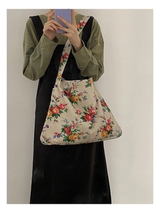 Close-up of large floral pattern on ivory canvas tote bag with red and yellow flowers