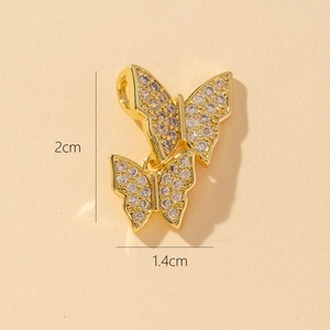 Detailed size view of a gold double butterfly pendant with rhinestones 2cm x 1.4cm