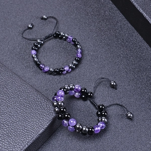 Detail of adjustable double-layer amethyst and black obsidian beaded bracelets on leather