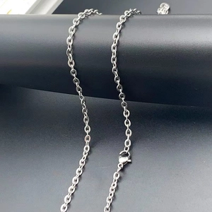 Detailed close-up of polished silver titanium steel chain with lobster claw clasp and extender