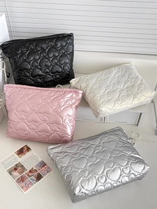 Quilted heart storage bags in black, pink, white, and silver with pearl zipper details