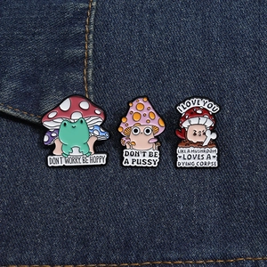 Three-piece mushroom enamel pin set with creative illustrations on denim background