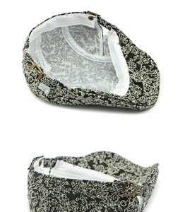 Close-up of jacquard beret with adjustable bronze buckle and internal sweatband detail