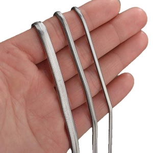 Three variations of minimalist silver stainless steel flat snake chains held by hand
