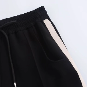 Detail view of elastic waistband with adjustable black drawstring and side white stripe