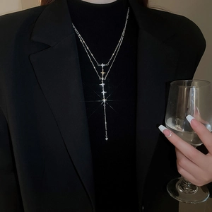 Close-up of double-layer silver star pendant necklace with sparkling crystal tassels