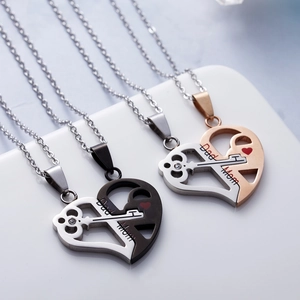 Close-up of heart puzzle couple necklaces with Dad and Mom engraving and small gems