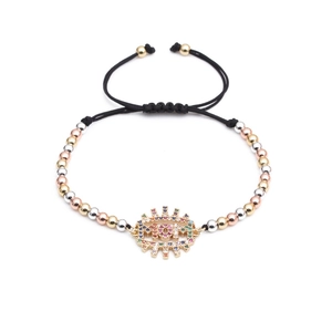 Detail of MOM letter charm with colorful zircon inlay on adjustable woven bead bracelet