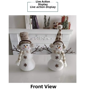 Detail view of two plush Christmas snowmen with brown plaid hats and branch-like arms