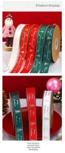 Close-up of Merry Christmas gold foil ribbons on kraft spools with festive decorations