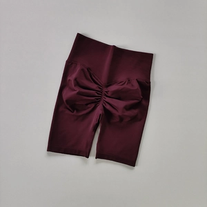 Detailed view of seamless scrunch butt lifting yoga shorts in deep burgundy red wine